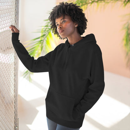 Woman wearing black essentials hoodie in bright indoor setting, comfort hoodie from Ghita Shop